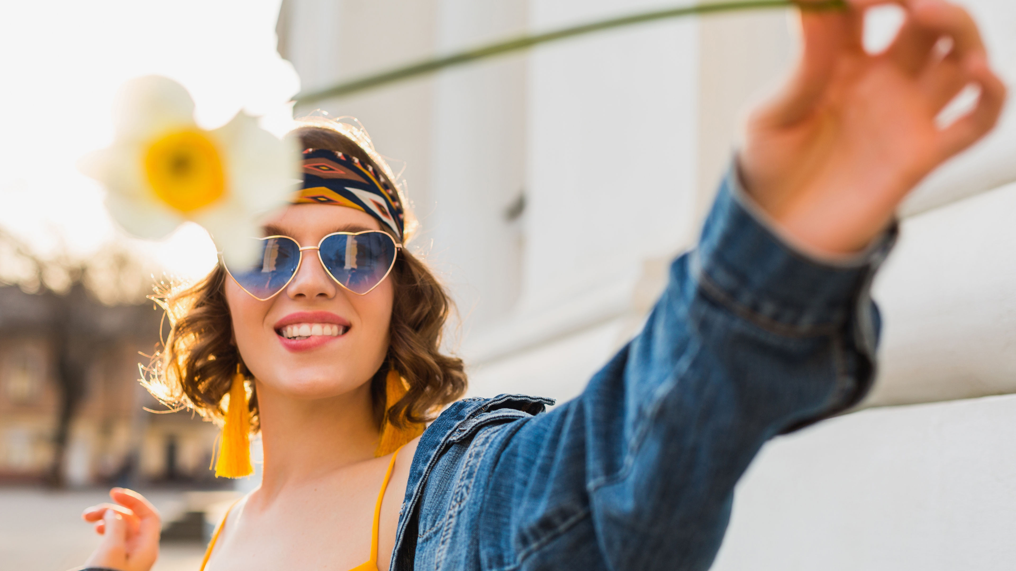 Woman with sunglass holding flower