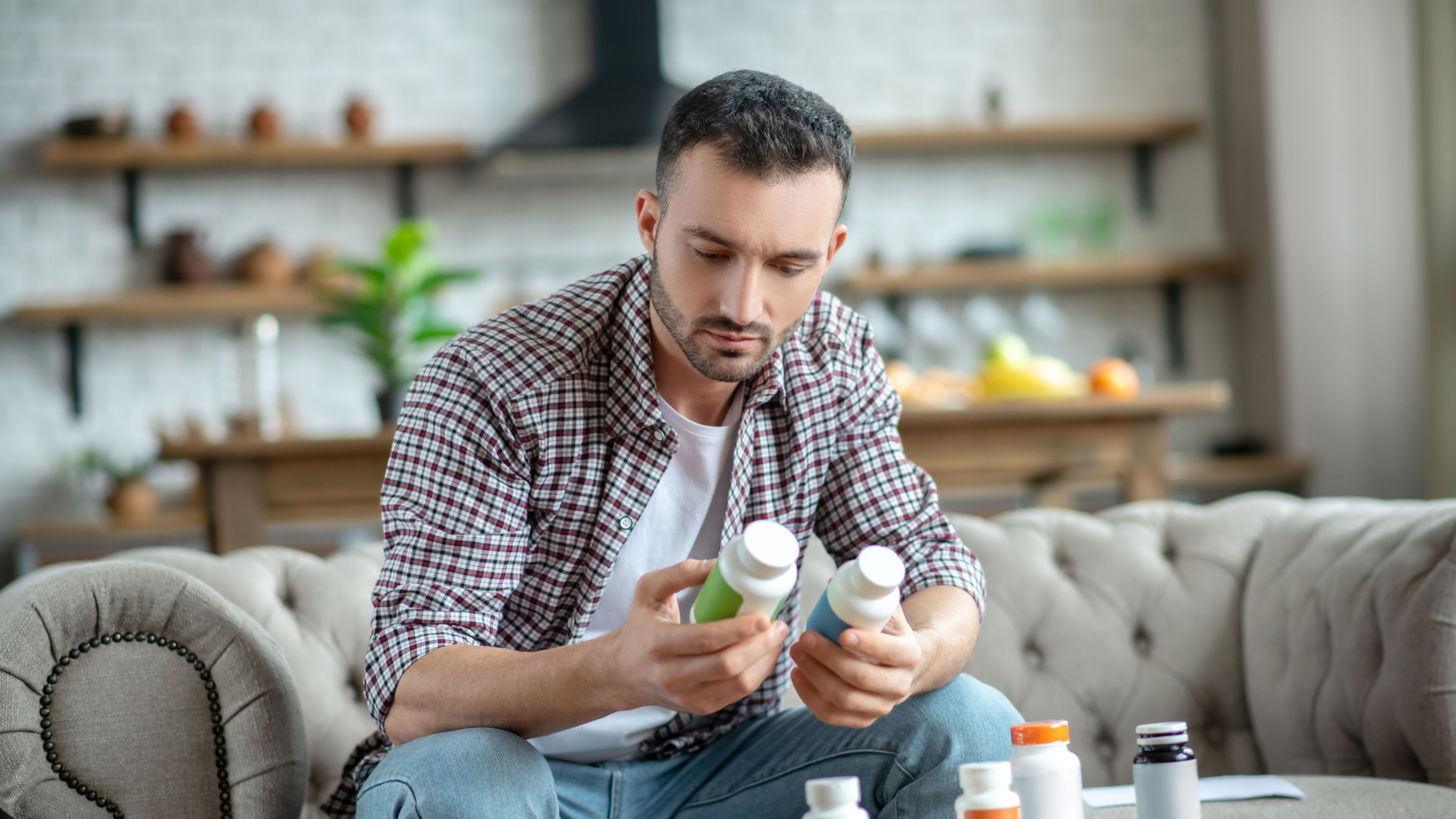 Young man choosing supplements