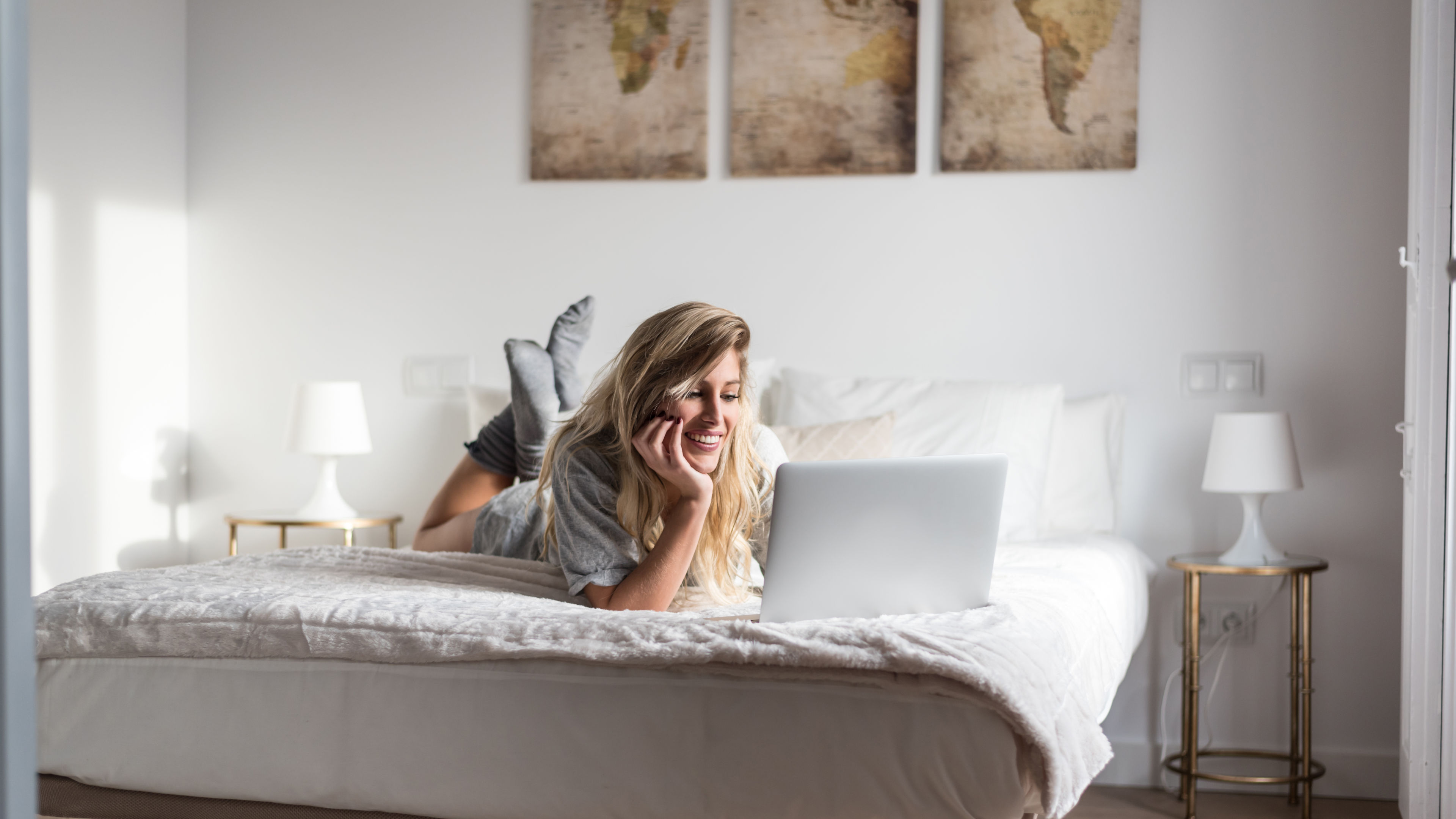 Young woman on bed with the computer